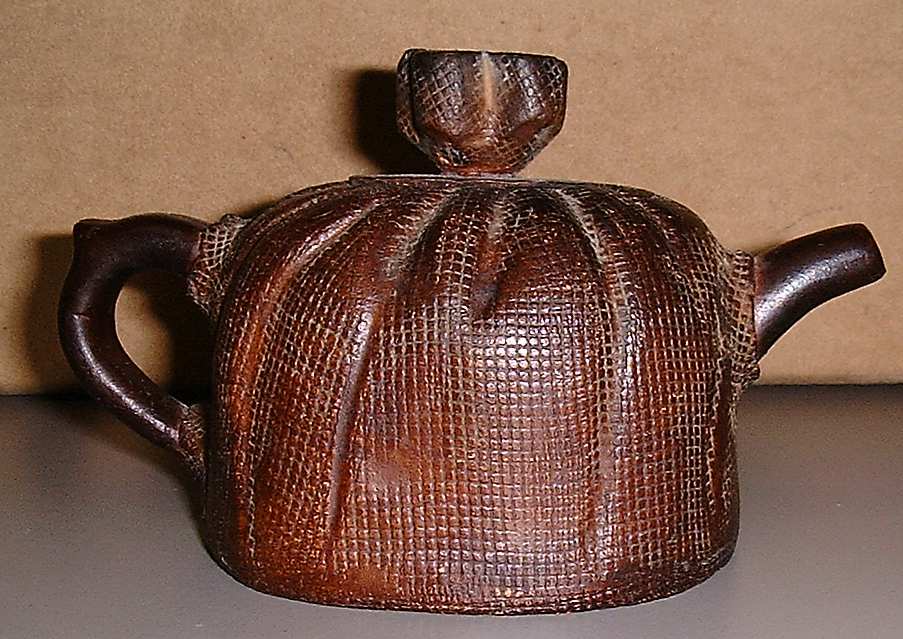 Clay tea pot which looks like a `meshed screen'
